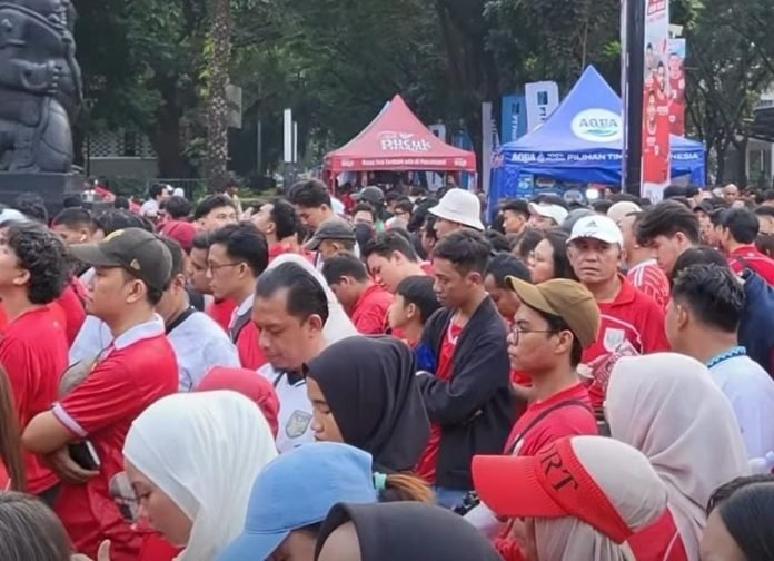 Supporter dengan jersey merah