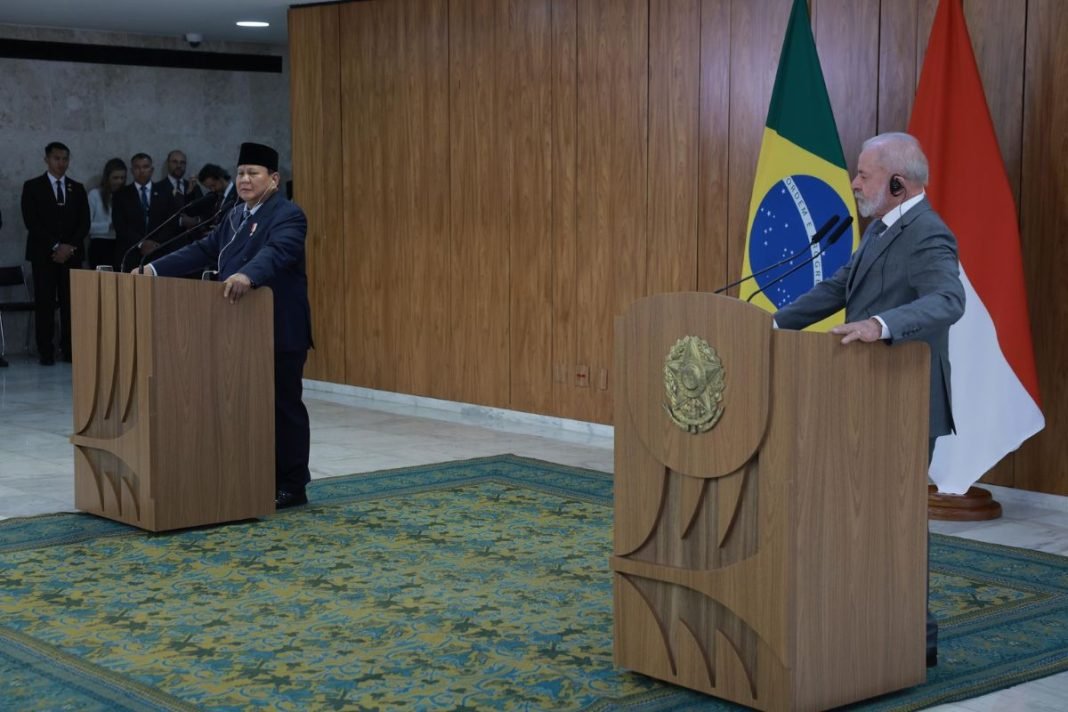Prabowo dan Lula bersalaman sambil tersenyum di Istana Palácio do Planalto